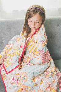 young-girl-brown-hair-wrapped-up-in-striped-floral-handmade-quilt-sugar-owl-design